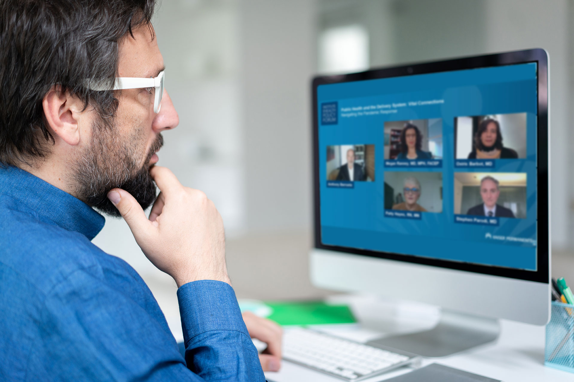 Man attending virtual conference on desktop computer