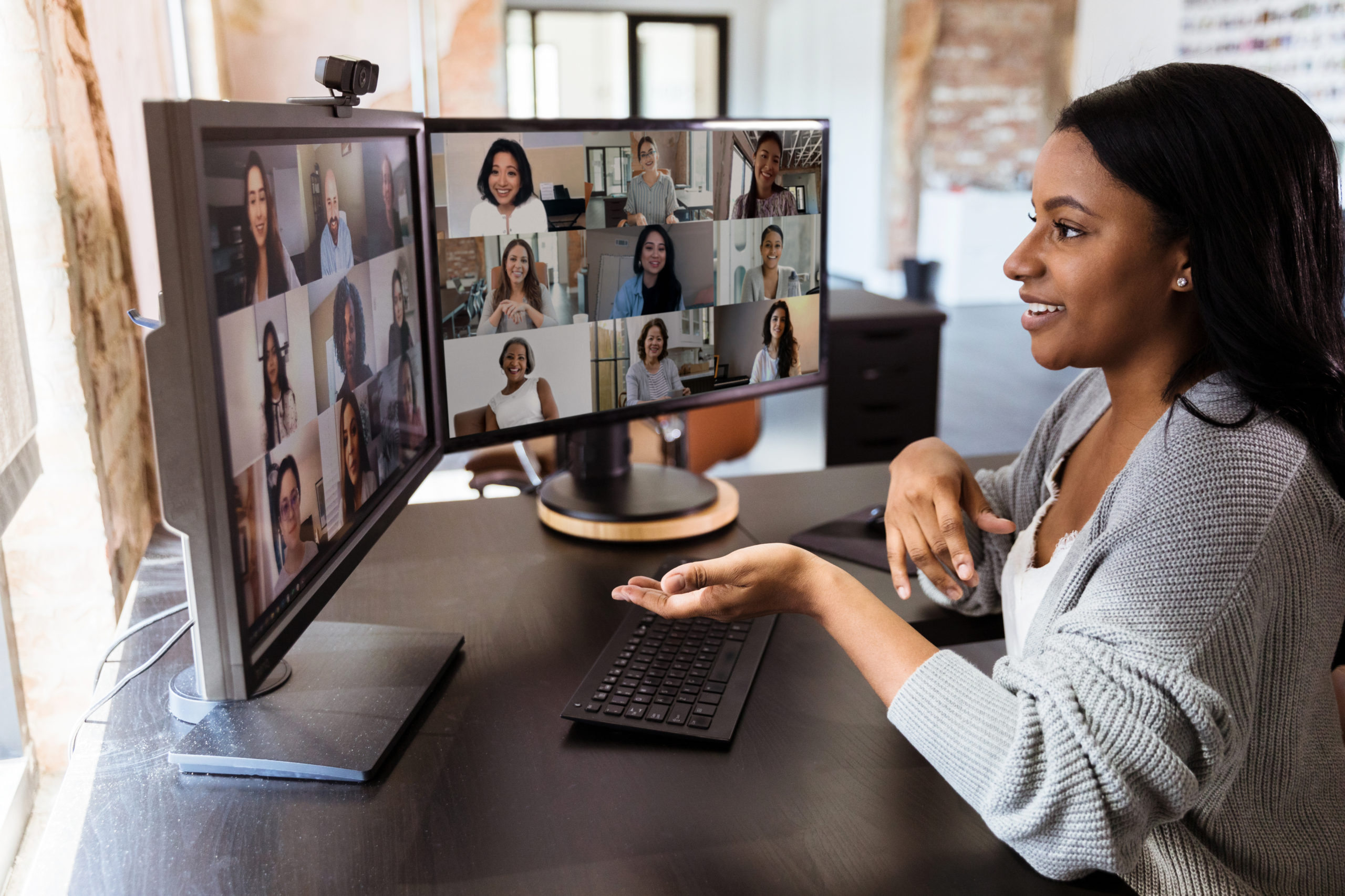 Person teleconferencing with their diverse colleagues.