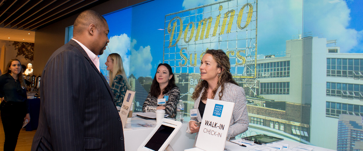 Woman assisting a man with forum check-in