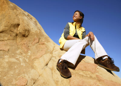 A woman sitting on a rock