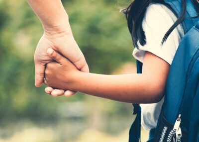 Adult holding small child's hand