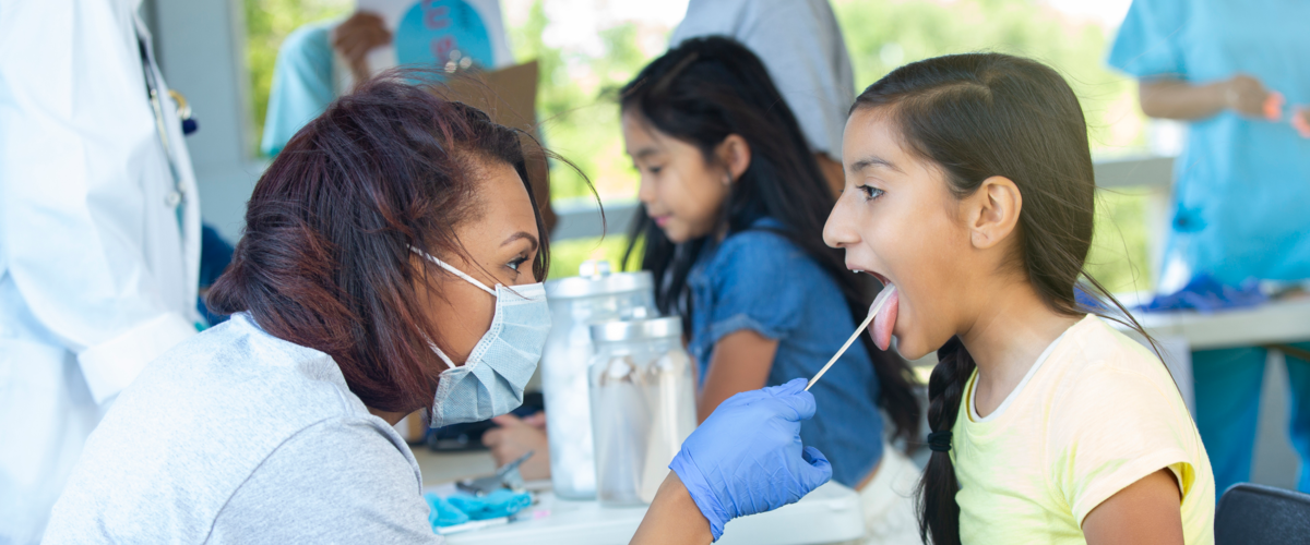 Nurse Swabbing A Child's Mouth