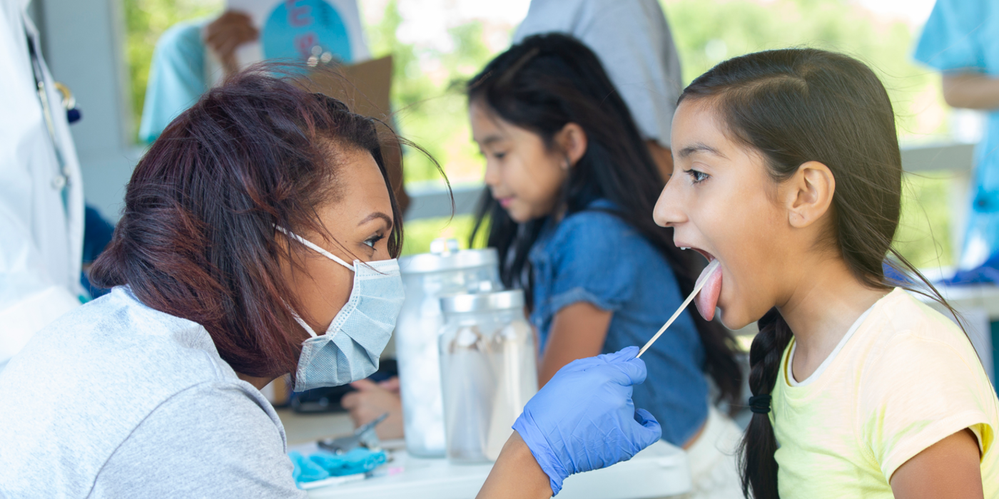 Nurse Swabbing A Child's Mouth