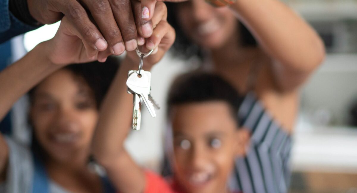 Latin family holding the keys of their new house