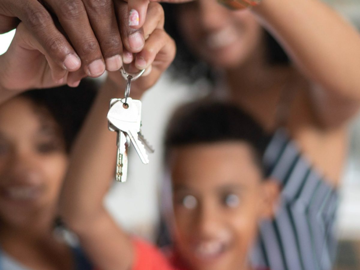 Latin Family Holding The Keys Of Their New House