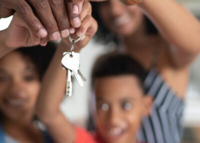 Latin family holding the keys of their new house