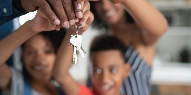 Latin family holding the keys of their new house