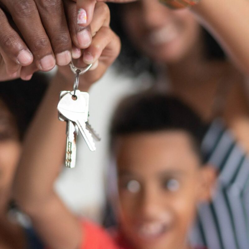 Latin family holding the keys of their new house