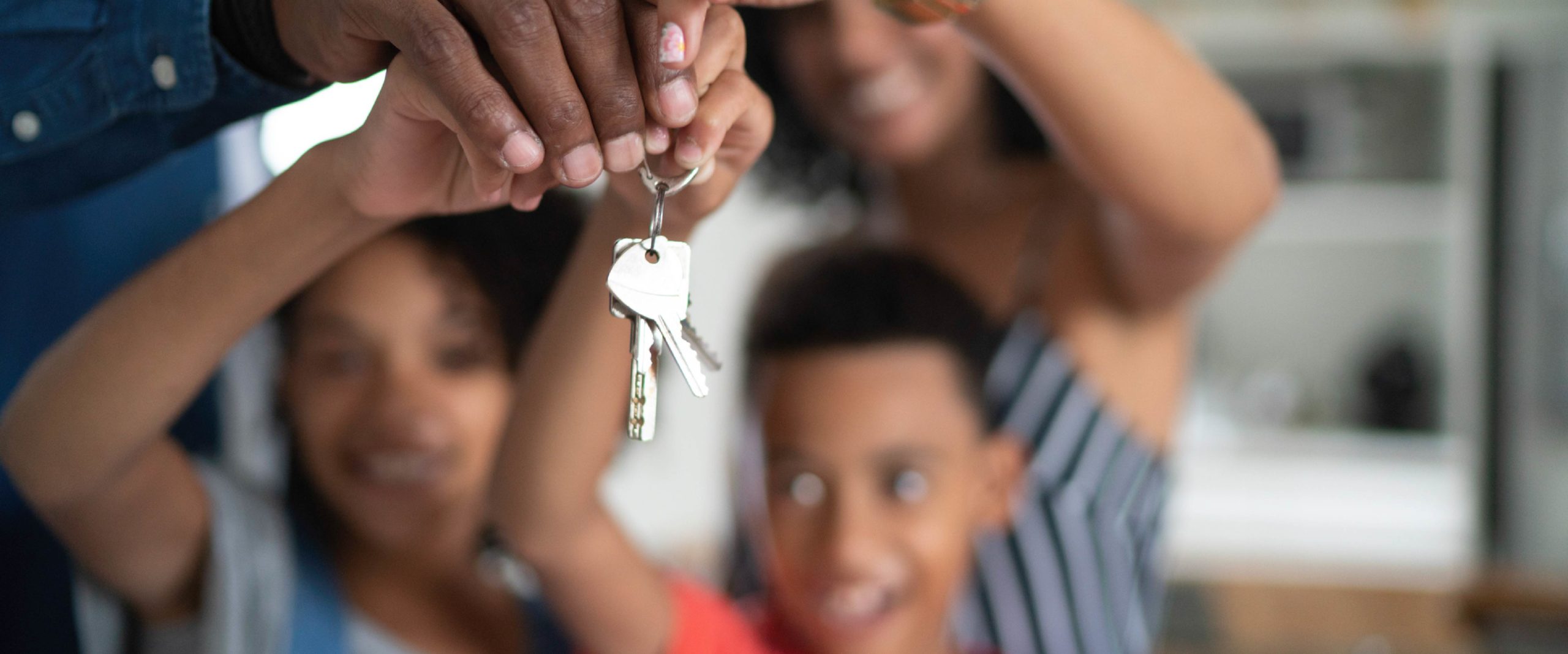 Latin family holding the keys of their new house