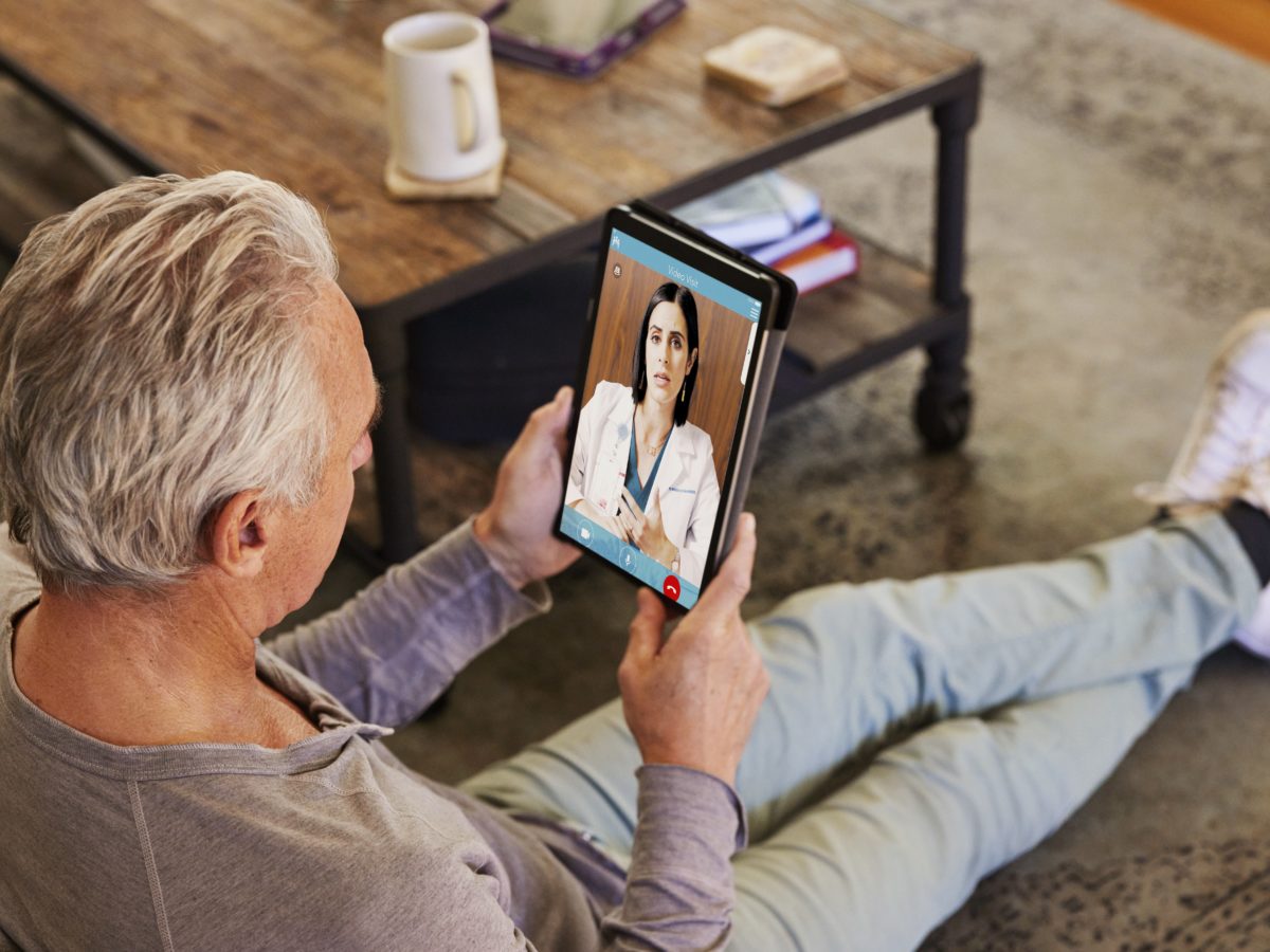 Man On Telehealth Visit With Doctor Using Tablet