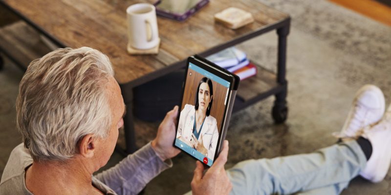 Man On Telehealth Visit With Doctor Using Tablet
