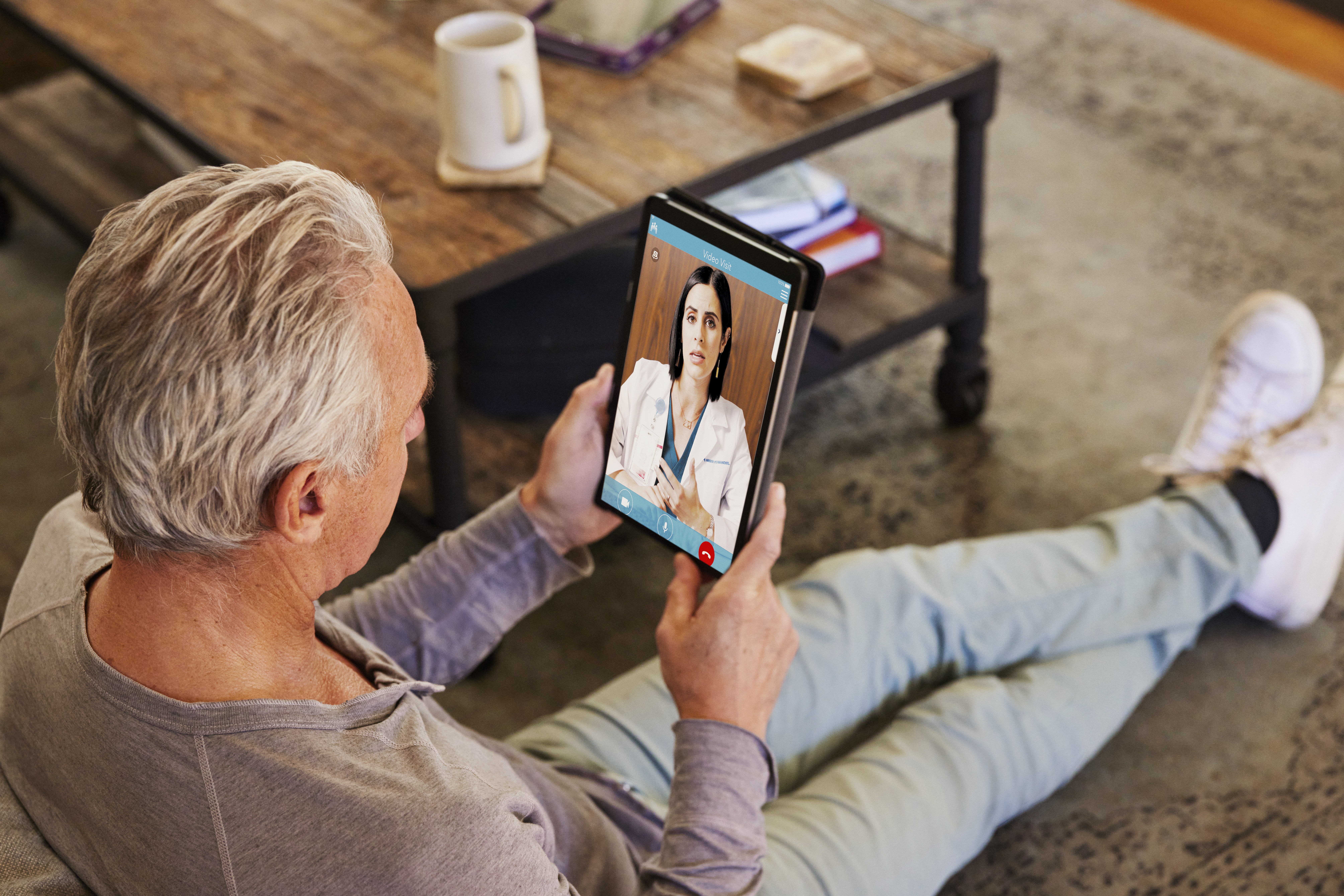 Man on telehealth visit with doctor using tablet