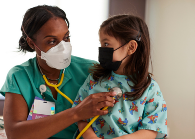 Nurse and child wearing masks