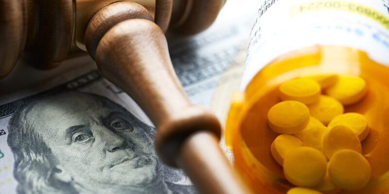 High Cost of Prescription Drugs: Concept prescription bottles with gavel