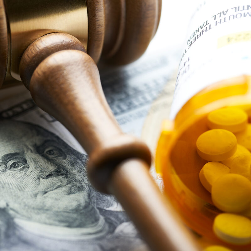 High Cost of Prescription Drugs: Concept prescription bottles with gavel