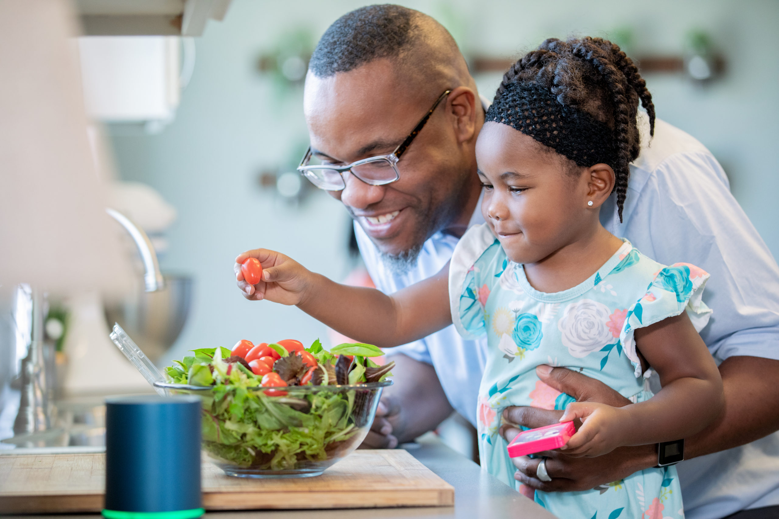 Toddler girl preparing food with father