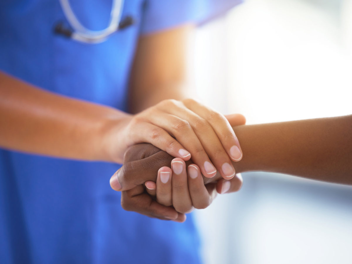 Shot Of An Unrecognizable Doctor Holding Hands With Her Patient During A Consultation