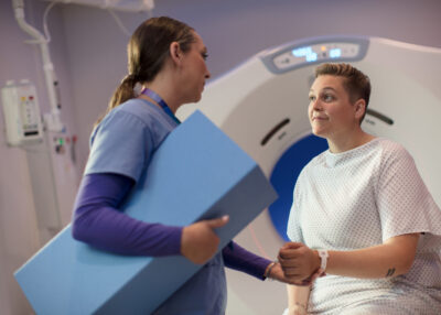 Nurse assisting patient with a scan