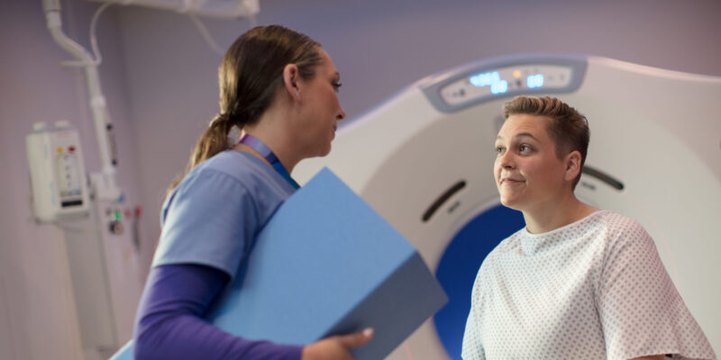 Nurse assisting patient with a scan