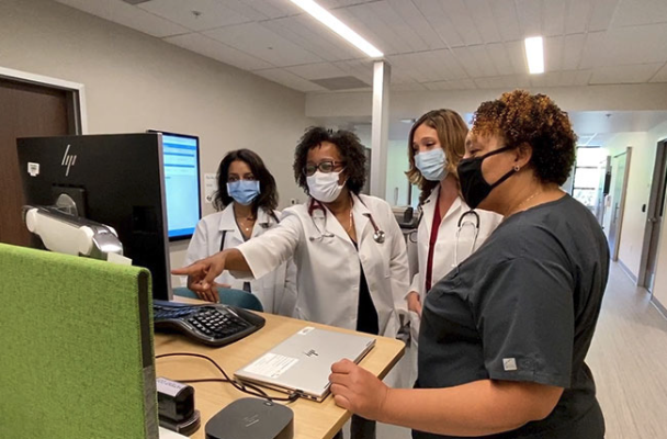 Health Care Workers Around A Computer