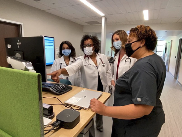 Health Care Workers Around A Computer