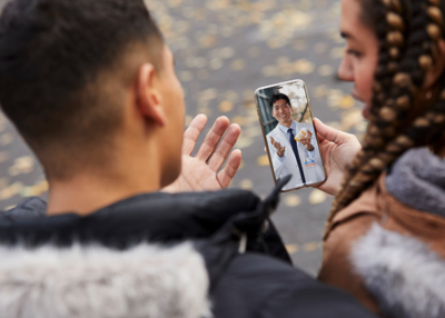 A young couple speaking to a physician on their mobile during a telehealth visit.