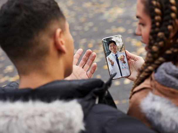 A Young Couple Speaking To A Physician On Their Mobile During A Telehealth Visit.