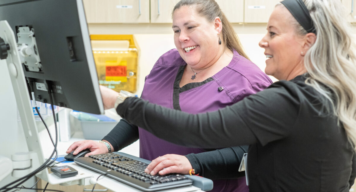 Healthcare workers at a computer